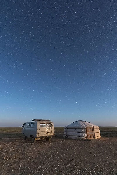 Mongolian traditional ger and soviet minivan under a starry sky. Ulziit, Middle Gobi province