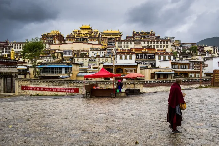 Framed Print : Monk walking in front at the Ganden Sumtseling Monastery, Zhongdian, Shangri-La County Framed Print : Monk walking in front at the Ganden Sumtseling Monastery, Zhongdian, Shangri-La County
