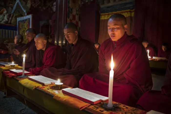 Framed Print : Monks during evening candle light prayer in Lhodrak Kharchu monastery, Jakar