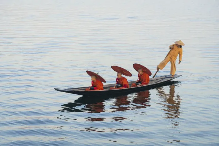 Framed Print : Three monks in orange robes with bowls for alms giving and a leg-rowing fisherman commute Framed Print : Three monks in orange robes with bowls for alms giving and a leg-rowing fisherman commute