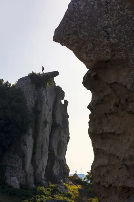 Framed Print : Montalbano Elicona, Messina. A man walking on the edge of the rock formations in