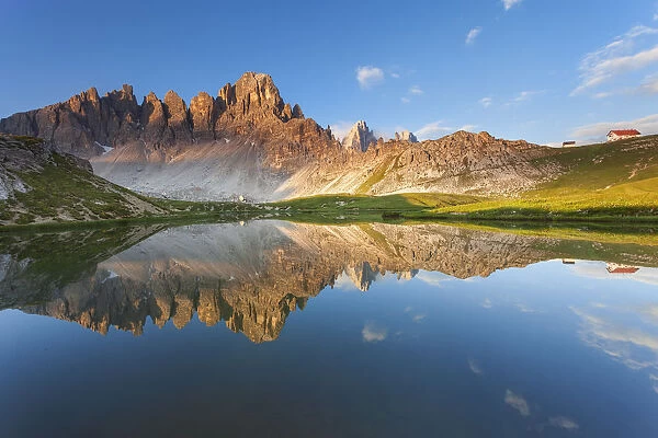 Monte Paterno, Dolomites, Italy. An alpine lake its reflecting the first lights