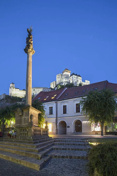 Monument in Mierove Square and Trencin Castle at dusk, Trencin, Trencin Region, Slovakia