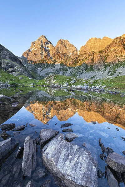 The Monviso Peak reflected in a small alpine lake at sunrise (Fiorenza Lake, Pian del Re