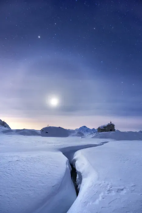 Framed Print : Moon halo in the night sky above a traditional mountain church during a winter full moon Framed Print : Moon halo in the night sky above a traditional mountain church during a winter full moon