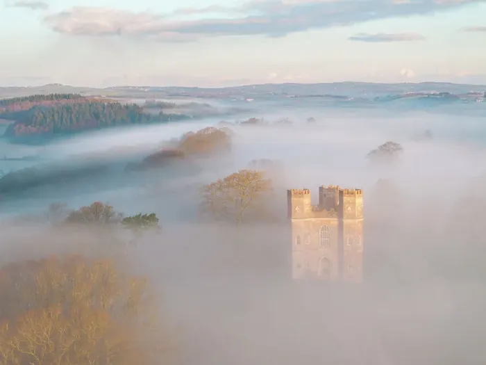 Framed Print : Morning mist surrounds The Belvedere tower at dawn on a winter morning, Powderham Castle, Devon, England. Winter (March) 2024