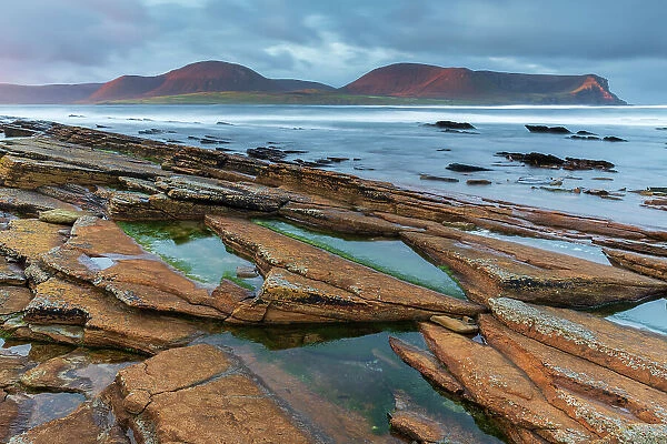 Morning sunlight on the mountains of Hoy from the distinctive ledges of Warebeth, Mainland, Orkney, Scotland. Autumn (October) 2022