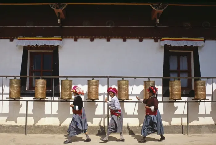 Framed Print : Mosu women push prayer wheels at a small monastery on Liwubi Island Framed Print : Mosu women push prayer wheels at a small monastery on Liwubi Island