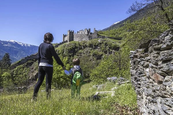 Mother accompanies her son to Castello Visconti Venosta above Grosio in Valtellina