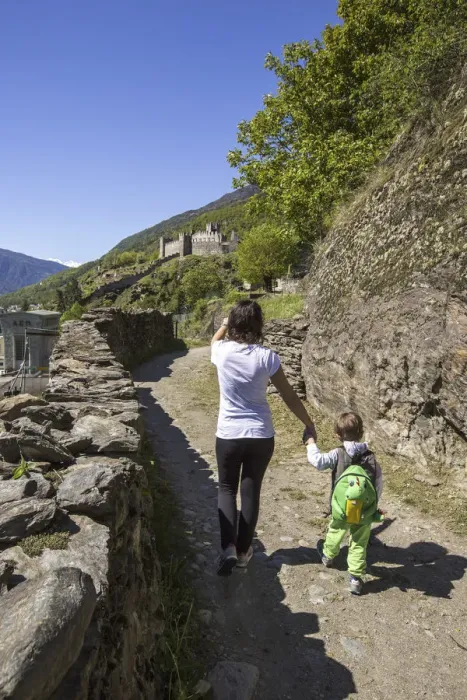 Framed Print : Mother accompanies her son down the path that leads to Castle Visconti Venosta. Grosio
