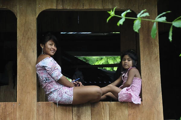 Mother and child sat on window, Ticuna Indian Village of Macedonia, Amazon River