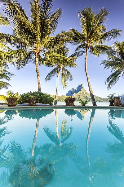 Mount Otemanu reflected in the swimming pool of a luxury resort, Bora Bora, French