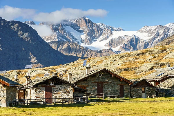 Mountain huts at Alpe Prabello with Palu-Bernina Group, Rhaetian Alps in the background