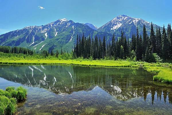 Mountain reflection on the Stewart Cassiar Highway near Bell ll, British Columbia, Canada