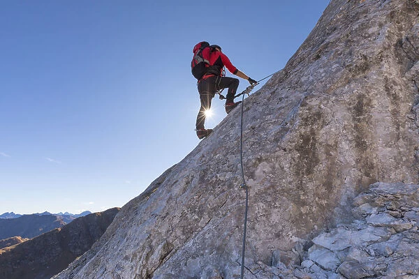 Mountaineer along the via ferrata on the north side of mount Gr. Kinigat, Kartitsch