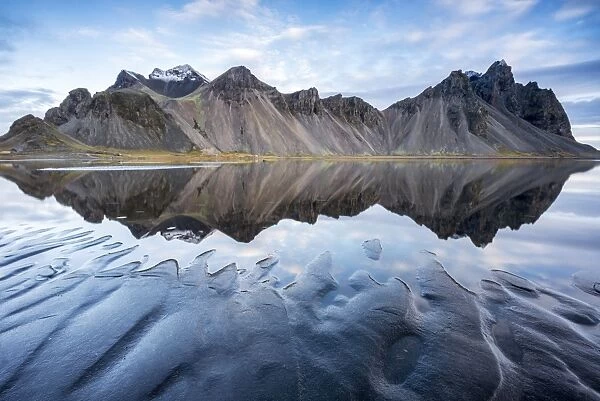 The mountains reflect on the surface of the ocean. Stokksnes, Eastern Iceland, Europe