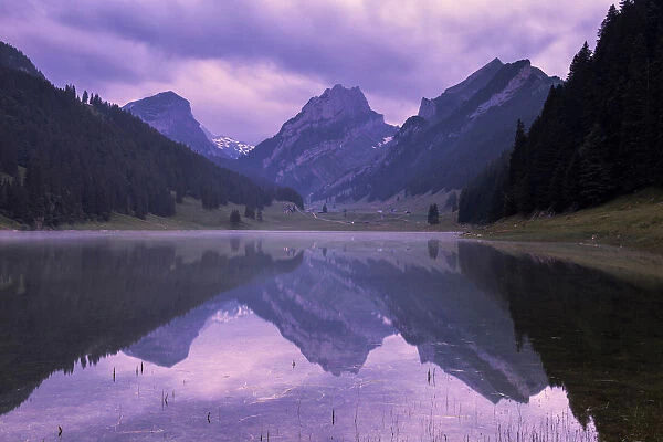 Mountains are reflected in the Samtisersee at sunrise, Canton of Appenzell, Alpstein
