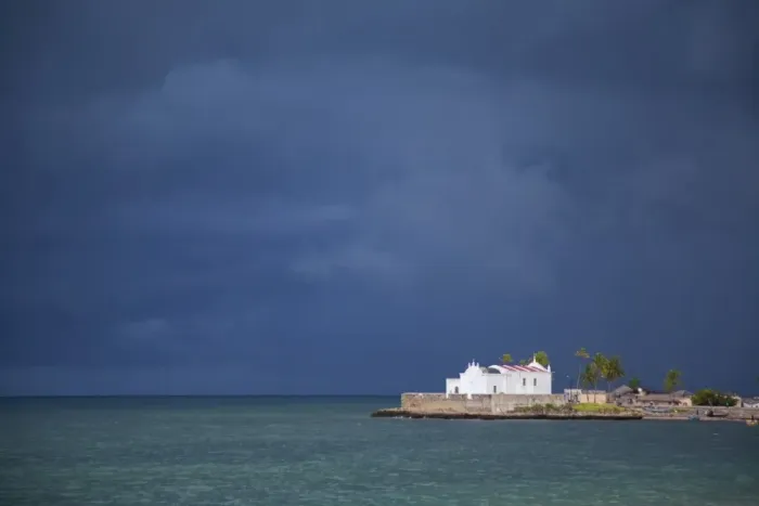 Framed Print : Mozambique, Ihla de Mozambique, Stone Town. The Church of Santo Antonio stands illuminated ahead of a dark approaching storm Framed Print : Mozambique, Ihla de Mozambique, Stone Town. The Church of Santo Antonio stands illuminated ahead of a dark approaching storm