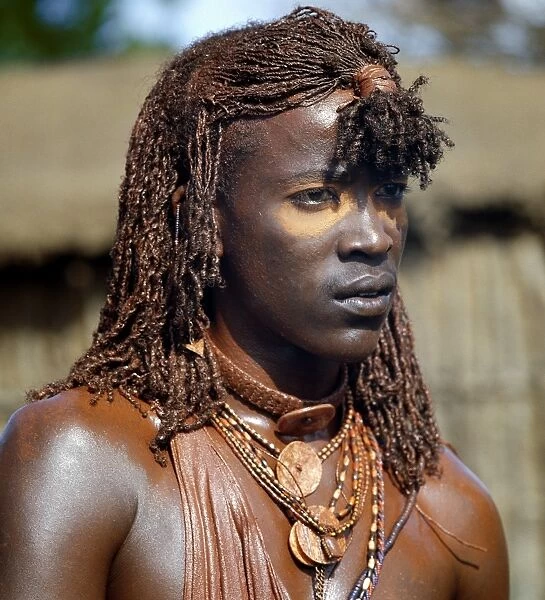 A Msai warrior with his long braids and body coated
