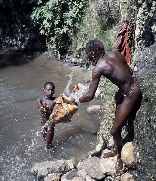 Msai warriors draw water for livestock from a well