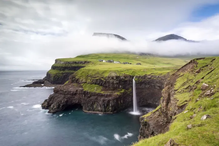 Framed Print : Mulafossur waterfall and the little village of Gasadalur, Vagar island, Faroe Islands