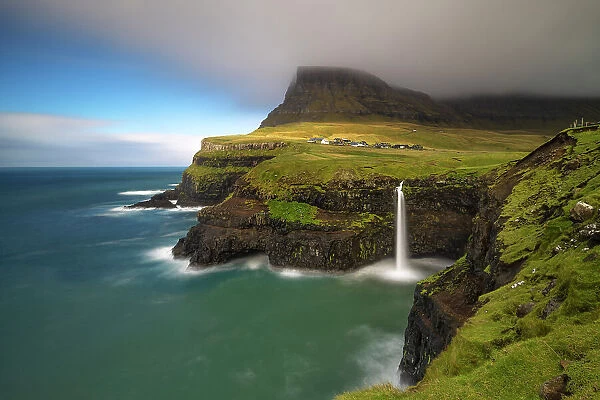 Mulafossur waterfall and the little village of Gasadalur, Vagar island, Faroe Islands, Denmark