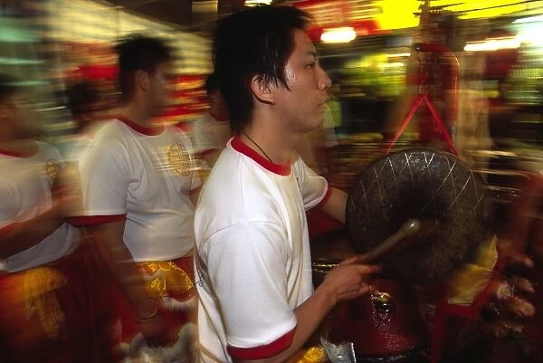 Musicians armed with drums and cymbals accompany Lion