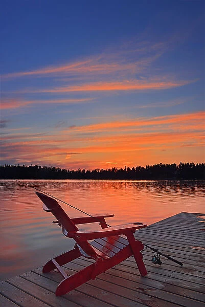 Muskoka chair at Star Lake at sunset Whiteshell Provincial Park, Manitoba, Canada