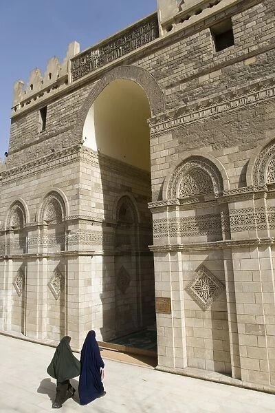 Two muslim women enter the Al-Hakim Mosque in Islamic Cairo, Egypt