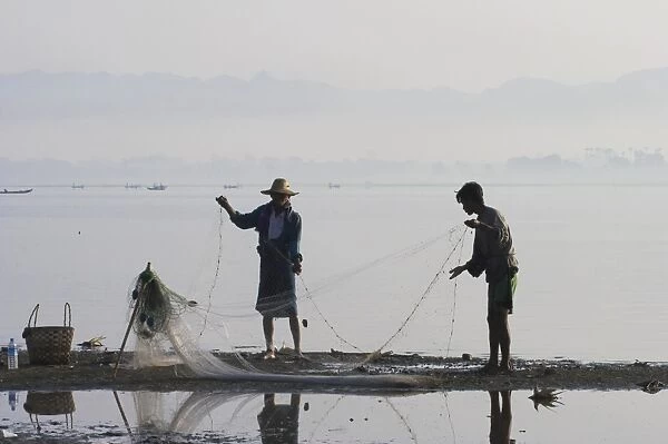 Myanmar (Burma), Mandalay, Amarapura, Taugthaman Lake, Men fishing near U Bein Bridge