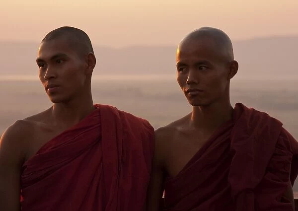 Myanmar, Burma, Mandalay. Monks enjoying the evening light, Mandalay Hill