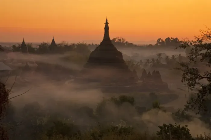 Framed Print : Myanmar, Burma, Mrauk U. Evening mist and smoke from village cooking fires swirl around Ratanabon Paya, Mrauk U
