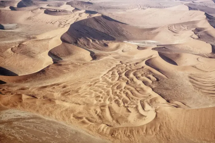 Framed Print : The Namib is an immense expanse of relentlessly moving gravel plains and dunes of