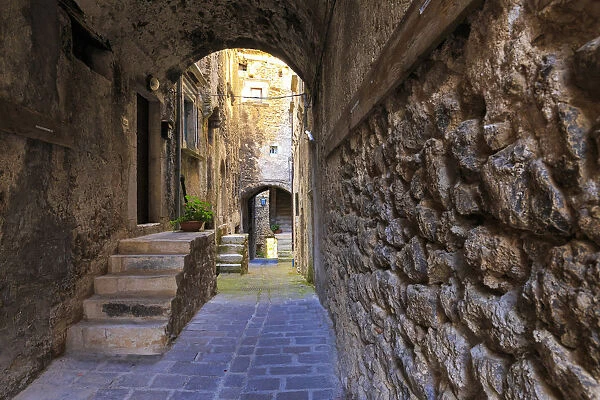 Narrow alley in the historic center of Castelvecchio Calvisio, Abruzzo, Italy