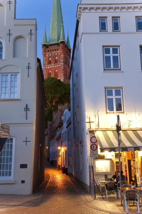 Framed Print : Narrow street to St Petri Church & cafe restaurant at dusk, Lubeck, Germany Framed Print : Narrow street to St Petri Church & cafe restaurant at dusk, Lubeck, Germany