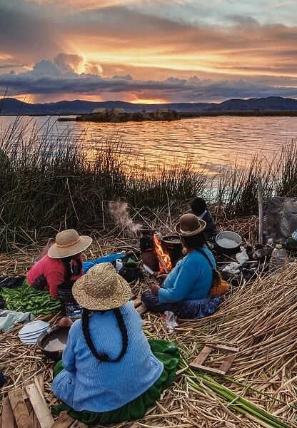 Native Uro Family dining at sunset, Uros Floating Islands, Lake Titicaca, Puno Region