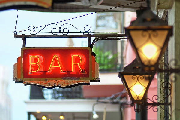Neon lite Bar sign hangs in the historic French Quarter of New Orleans. Louisiana, USA
