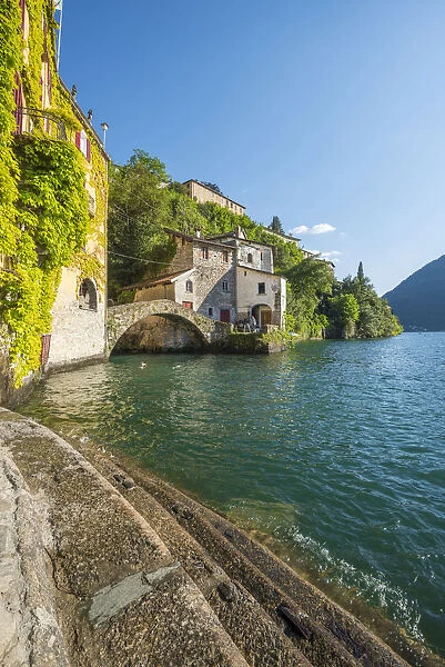Nesso, lake Como, Como province, Italy. Lake shore and the roman stone bridge