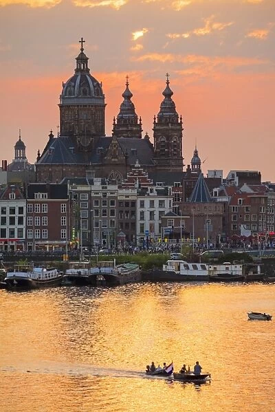 Netherlands, North Holland, Amsterdam. City skyline at sunset with domes of Basilica