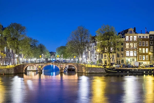 Netherlands, North Holland, Amsterdam. Canal houses along the Amstel River at night