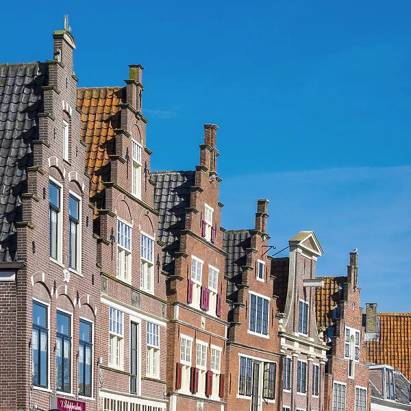Netherlands, North Holland, Hoorn. Historic building facades along the Binnenhaven