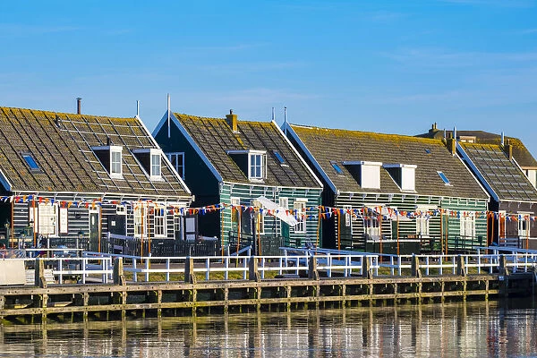 Netherlands, North Holland, Marken. Wooden buildings along the harbor in Havenbuurt