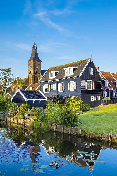 Netherlands, North Holland, Marken. Wooden houses along a canal in Kerkbuurt village