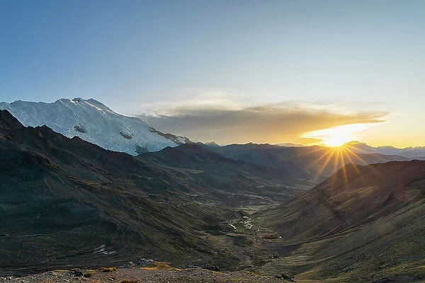 Nevado Ausangate rising over valley in Andes at sunrise, near Rainbow mountain, near Uchullujllo, Pitumarca district, Canchis Province, Cuzco Region, Peru