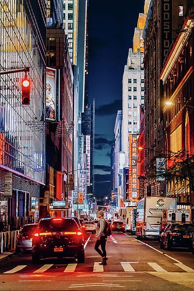New York City streets at night, people and city lights, USA