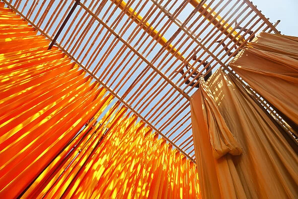 Newly dyed fabric being hung up to dry, Sari garment factory, Rajasthan, India, (MR  /  PR)