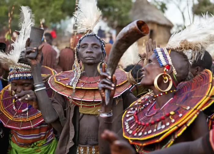 Framed Print : During a Ngetunogh ceremony, the mothers of Pokot initiates sing and dance holding high the cowhorn containers they used to smear fat over the masks of their sons as