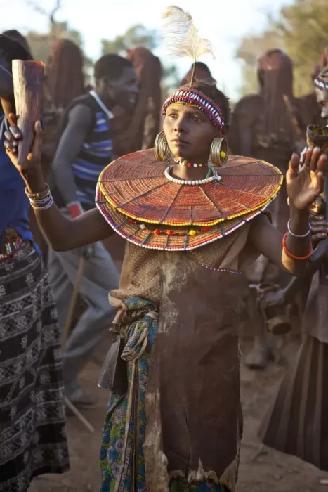 Framed Print : During a Ngetunogh ceremony, the mother of a Pokot initiate sings and dances holding high the cowhorn container she used to smear fat over the masks of her son and other boys as Framed Print : During a Ngetunogh ceremony, the mother of a Pokot initiate sings and dances holding high the cowhorn container she used to smear fat over the masks of her son and other boys as
