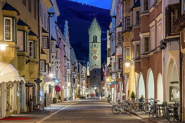 Night view of the main street with Zwolferturm medieval tower in the background, Sterzing-Vipiteno, Trentino-Alto Adige / Sudtirol, Italy