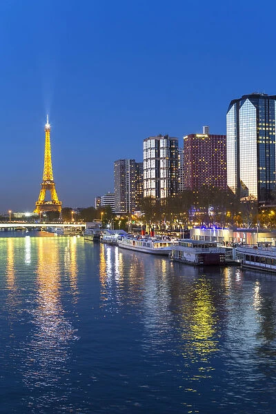Night view of River Seine with high-rise buildings on the Left Bank, and Eiffel Tower